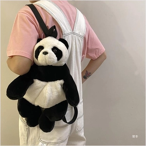 Detail view of large plush panda backpack with soft fur texture and black nylon straps