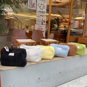 Set of six colorful faux lamb wool cosmetic bags in black white yellow blue and green