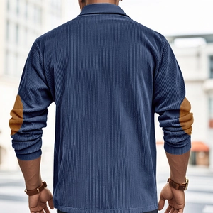 Detail view of corduroy texture and brown elbow patches on a men's navy long sleeve polo