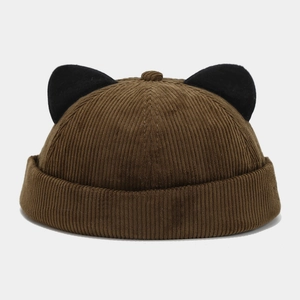 Detail of coffee corduroy skull cap featuring decorative black plush cat ears