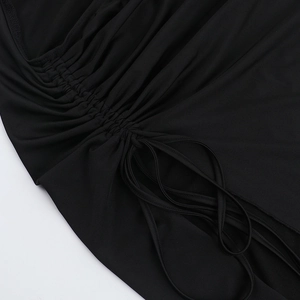 Close-up of black slit dress showing intricate drawstring and ruched fabric details