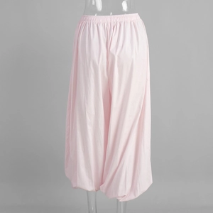 Detail of pink cotton harem pants showing the elastic waist and loose lantern cut design