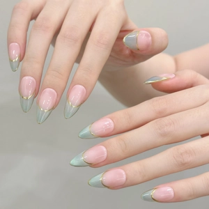 Green cat-eye almond press-on nails with French tips and elegant gold line detailing