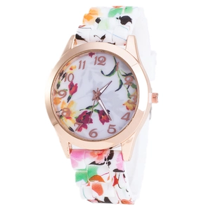 Detail of rose gold quartz watch with vibrant floral print on dial and silicone strap