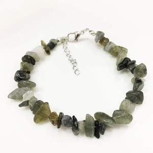 Detailed macro view of irregular raw labradorite gemstone beads with silver lobster clasp