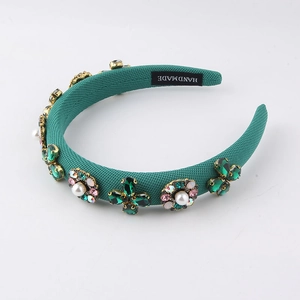 Detail of emerald velvet headband with hand-set pearls and green rhinestones