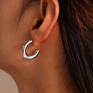 Polished silver C-shaped chunky hoop earrings with minimalist irregular metal design