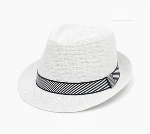 Detailed texture of white straw weave hat with decorative black and white striped ribbon