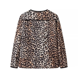 Back view of women's vintage leopard print quilted jacket with black piping trim details