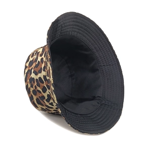 Reversible leopard print bucket hat with wide brim showing both pattern and black lining