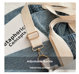 Detail of white woven corduroy bag strap with gold metal buckle and swivel lobster clasp
