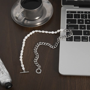 French vintage freshwater pearl and silver chain necklace with OT clasp on a desk