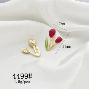 Detailed view of tulip-shaped gold metal earrings with red enamel and size 24mm x 17mm