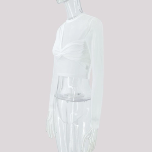 Detail of white mesh cropped top featuring a front twist design and long sheer sleeves