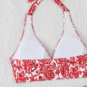 Detail of red paisley bikini top featuring breathable mesh lining and removable pads