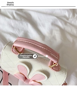 Detail shot of the comfortable pink handle and quilted cream white fabric on girls' bag