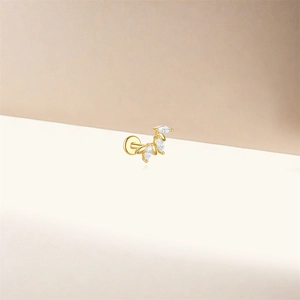 Detailed view of a gold s925 silver leaf stud earring with marquise-cut stones