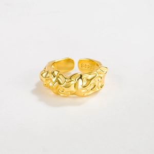Detailed close-up of S925 sterling silver stamp on golden textured lava open ring