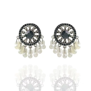 Detailed view of silver ethnic earrings featuring black stones and pearl drops