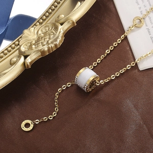 Elegant gold titanium steel necklace featuring white cat eye stone and pavé crystal rim