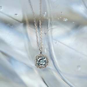 Macro shot of aquamarine pendant with halo diamond setting on 925 sterling silver chain