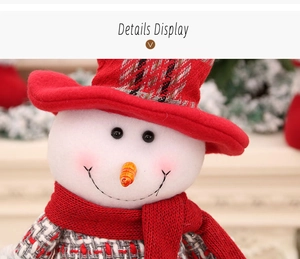 Close-up of a Christmas snowman doll featuring a red plaid body and a knitted scarf