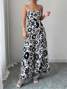 Detail of elegant black and white floral jumpsuit featuring a cutout twist bust design