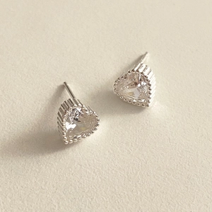 Macro shot of 925 sterling silver heart stud earrings with clear zircon stones