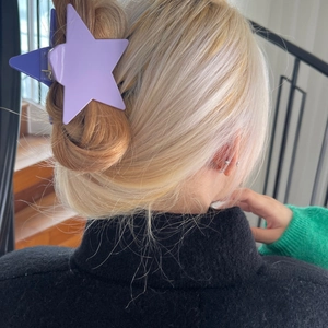 Purple star-shaped claw clip for hair styling with a matte finish and layered design