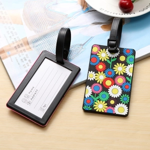 Black PVC luggage tag set with vibrant daisy floral pattern and secure adjustable buckle strap