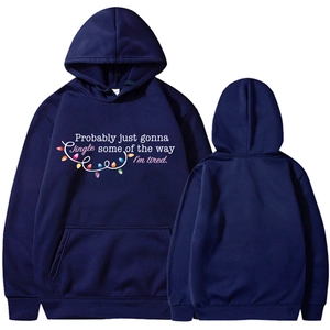 Navy hoodie detail showing festive colorful light strings and holiday typography print