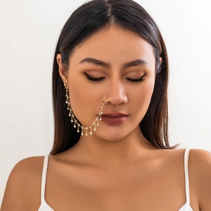 Detail of gold chain nose ring with white rhinestones on model, ethnic bohemian style