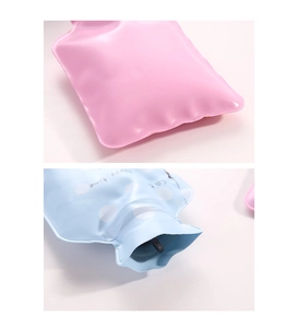 Detail view of pink and blue PVC hot water bottles with leak-proof screw top neck