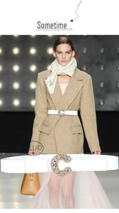 Close-up of sparkling rhinestone C-buckle on an elegant white leather waist belt