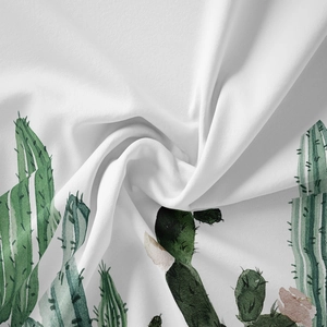 Detailed close-up of white bohemian tapestry fabric with green cactus and pink floral prints