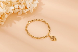 Detail of gold-plated Hamsa Hand bracelet with oval link chain and secure lobster clasp
