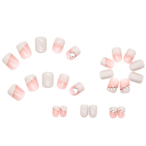 Pink gradient press-on nails with 3D silver heart and rhinestone accents in a set