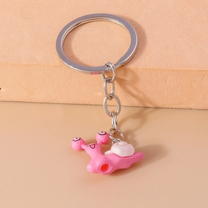 Close-up of a cute pink snail keychain with durable metal ring and chain attachment
