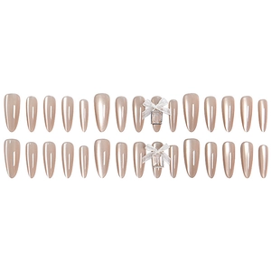 Champagne pearl almond press-on nails with 3D white bow and square gem accents