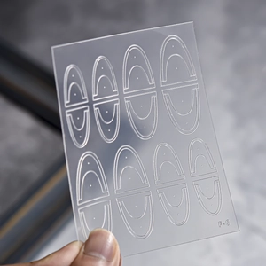 Close-up of F-6 French manicure stencil stickers showing 8 sets of curved guiding lines