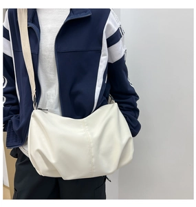 Detailed close-up of white pleated cloud bag showing soft leather texture and large capacity