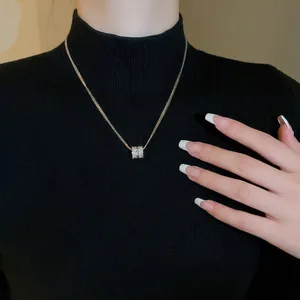 Elegant gold plated multi-layer zircon cylinder pendant necklace for women shown on neck