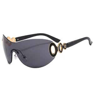 Modern Y2K rimless shield sunglasses with dark grey lenses and gold chain link temples