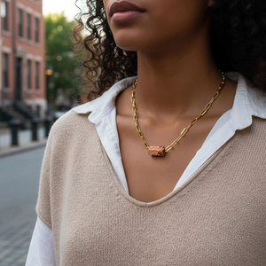Gold chunky chain necklace featuring a cylindrical AMOUR pendant with red stripe accents