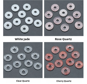 Detail view of jade, rose quartz, and clear quartz donut charms for jewelry making