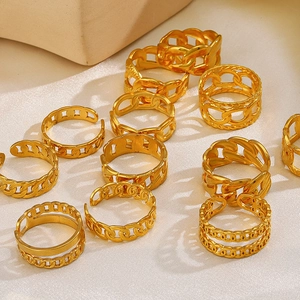 Close-up of vintage 18K gold plated chain rings on cream fabric background