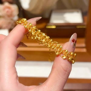 Close-up of a multi-layer 24K gold-plated beaded bracelet featuring matte finish details