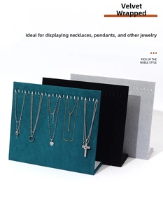 Velvet jewelry display stand with metal hooks for necklaces and pendants in green and black