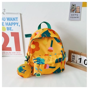 Detail of yellow floral kids backpack with green handle and matching round coin purse