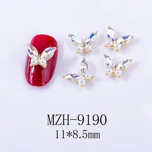 Macro detail of 3D aurora butterfly nail charms with gold alloy and AB crystals